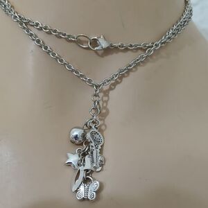 Long silver chain with 6 different charms in the front